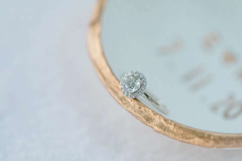 Ring shot in Custom Ring Dish -  Ideas for what to wear for Engagement Photography, Modern Engagement Session Inspiration Wardrobe Ideas. Unsure of what to wear for your engagement photos, we've got you! Romantic blue Romper and neutral Shirts and polo. Boat Shoes and Flip Flops. Engagement in Gananoque. Grey Loft Studio is Ottawa's Wedding and Engagement Photographer Videographer for Real couples, showcasing photos that are modern, bright, and fun.