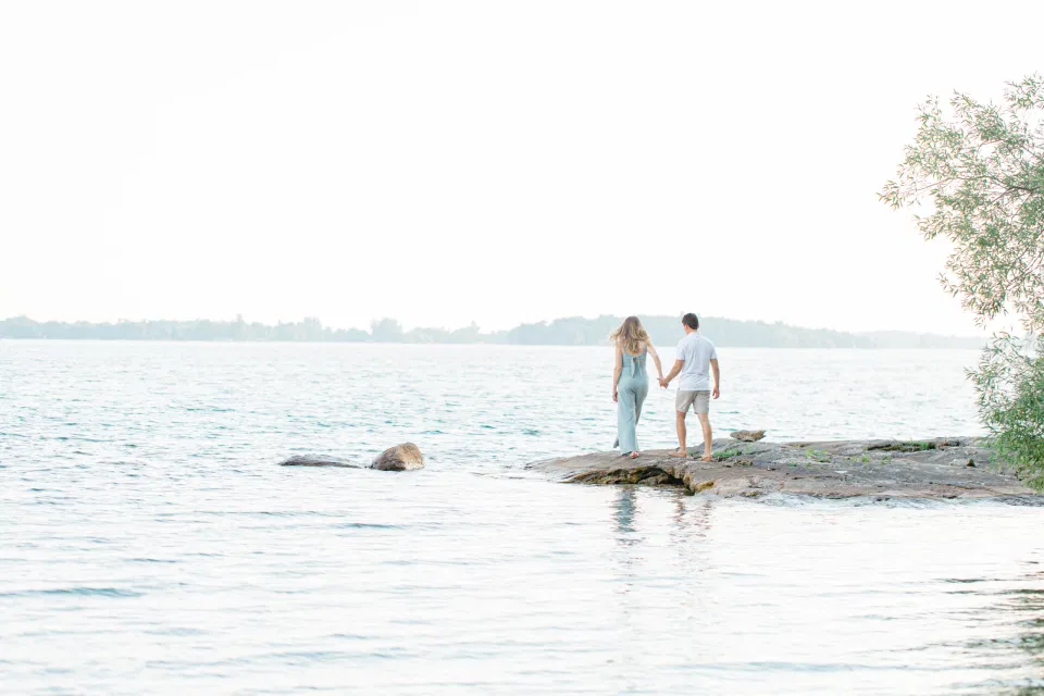 Ideas for what to wear for Engagement Photography, Modern Engagement Session Inspiration Wardrobe Ideas. Unsure of what to wear for your engagement photos, we've got you! Romantic blue Romper and neutral Shirts and polo. Boat Shoes and Flip Flops. Engagement in Gananoque. Grey Loft Studio is Ottawa's Wedding and Engagement Photographer Videographer for Real couples, showcasing photos that are modern, bright, and fun.