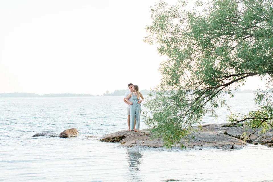 Ideas for what to wear for Engagement Photography, Modern Engagement Session Inspiration Wardrobe Ideas. Unsure of what to wear for your engagement photos, we've got you! Romantic blue Romper and neutral Shirts and polo. Boat Shoes and Flip Flops. Engagement in Gananoque. Grey Loft Studio is Ottawa's Wedding and Engagement Photographer Videographer for Real couples, showcasing photos that are modern, bright, and fun.