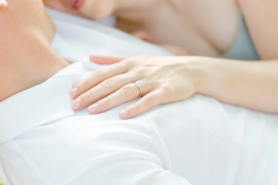 Ring Shot - Ideas for what to wear for Engagement Photography, Modern Engagement Session Inspiration Wardrobe Ideas. Unsure of what to wear for your engagement photos, we've got you! Romantic blue Romper and neutral Shirts and polo. Boat Shoes and Flip Flops. Engagement in Gananoque. Grey Loft Studio is Ottawa's Wedding and Engagement Photographer Videographer for Real couples, showcasing photos that are modern, bright, and fun.