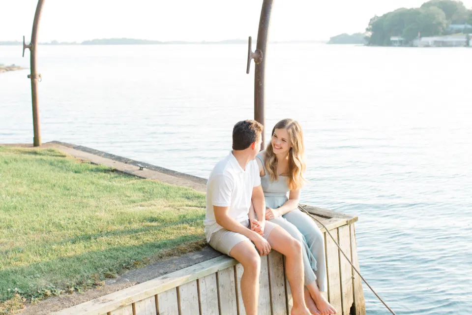 Ideas for what to wear for Engagement Photography, Modern Engagement Session Inspiration Wardrobe Ideas. Unsure of what to wear for your engagement photos, we've got you! Romantic blue Romper and neutral Shirts and polo. Boat Shoes and Flip Flops. Engagement in Gananoque. Grey Loft Studio is Ottawa's Wedding and Engagement Photographer Videographer for Real couples, showcasing photos that are modern, bright, and fun.