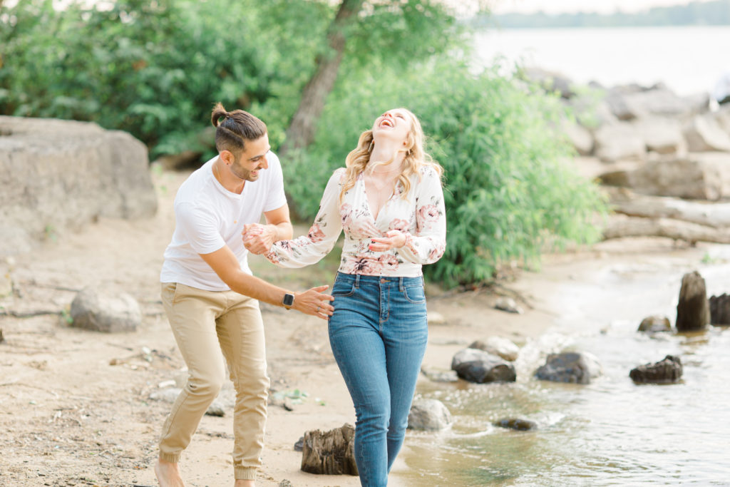 Walking on the Beach - Ideas for what to wear for Engagement Photography, Modern Engagement Session Inspiration Wardrobe Ideas. Unsure of what to wear for your engagement photos, we've got you! Romantic floral shirt & jeans.  White T-shirt & neutral pants . Boat Shoes and Fancy. beaded sandals. Engagement at Petrie Island, Orleans. Grey Loft Studio is Ottawa's Wedding and Engagement Photographer Videographer for Real couples, showcasing photos that are modern, bright, and fun.
