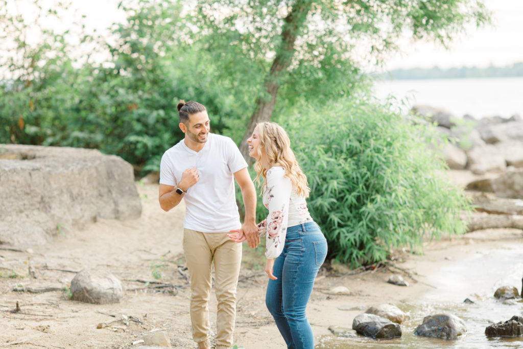 Walking on the Beach - Ideas for what to wear for Engagement Photography, Modern Engagement Session Inspiration Wardrobe Ideas. Unsure of what to wear for your engagement photos, we've got you! Romantic floral shirt & jeans.  White T-shirt & neutral pants . Boat Shoes and Fancy. beaded sandals. Engagement at Petrie Island, Orleans. Grey Loft Studio is Ottawa's Wedding and Engagement Photographer Videographer for Real couples, showcasing photos that are modern, bright, and fun.