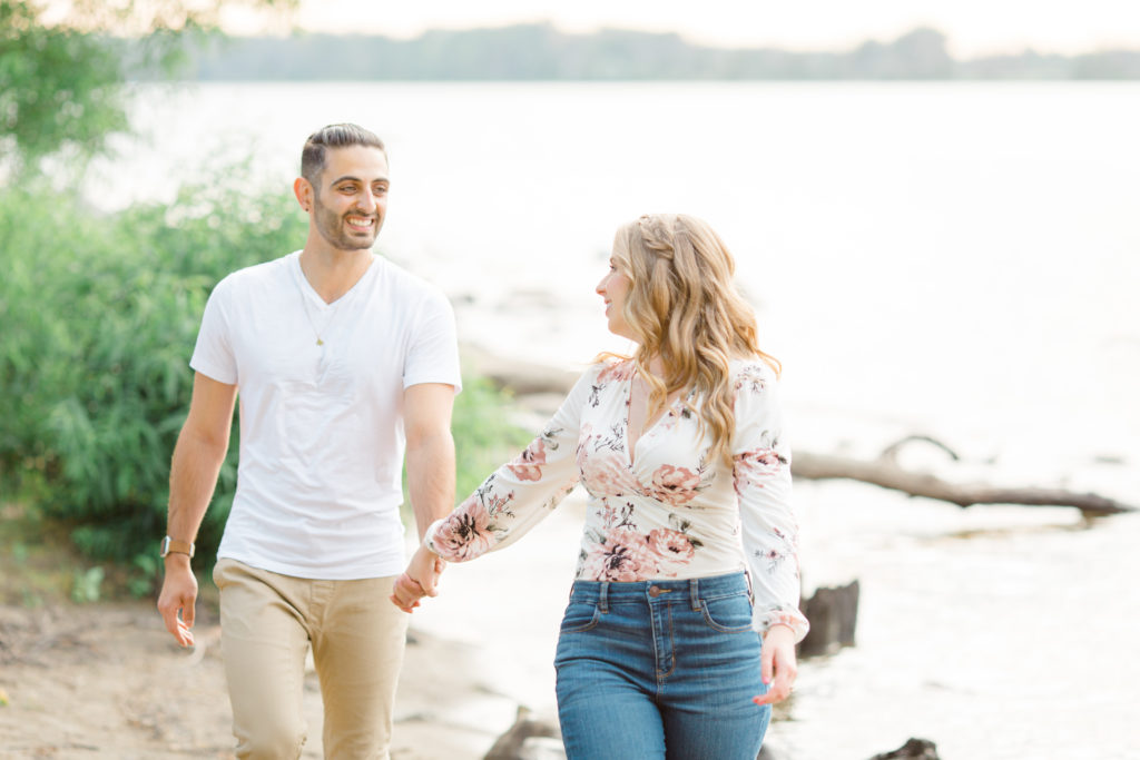 Walking on the Beach - Ideas for what to wear for Engagement Photography, Modern Engagement Session Inspiration Wardrobe Ideas. Unsure of what to wear for your engagement photos, we've got you! Romantic floral shirt & jeans.  White T-shirt & neutral pants . Boat Shoes and Fancy. beaded sandals. Engagement at Petrie Island, Orleans. Grey Loft Studio is Ottawa's Wedding and Engagement Photographer Videographer for Real couples, showcasing photos that are modern, bright, and fun.