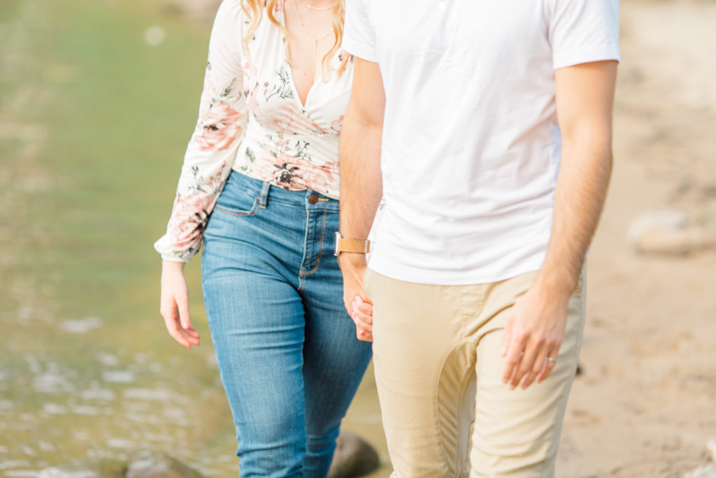 Walking on the Beach - Ideas for what to wear for Engagement Photography, Modern Engagement Session Inspiration Wardrobe Ideas. Unsure of what to wear for your engagement photos, we've got you! Romantic floral shirt & jeans.  White T-shirt & neutral pants . Boat Shoes and Fancy. beaded sandals. Engagement at Petrie Island, Orleans. Grey Loft Studio is Ottawa's Wedding and Engagement Photographer Videographer for Real couples, showcasing photos that are modern, bright, and fun.