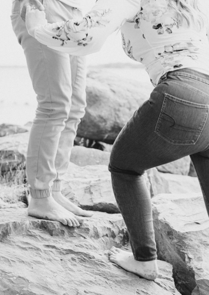 Cute Poses on the beach - Ideas for what to wear for Engagement Photography, Modern Engagement Session Inspiration Wardrobe Ideas. Unsure of what to wear for your engagement photos, we've got you! Romantic floral shirt & jeans.  White T-shirt & neutral pants . Boat Shoes and Fancy. beaded sandals. Engagement at Petrie Island, Orleans. Grey Loft Studio is Ottawa's Wedding and Engagement Photographer Videographer for Real couples, showcasing photos that are modern, bright, and fun.