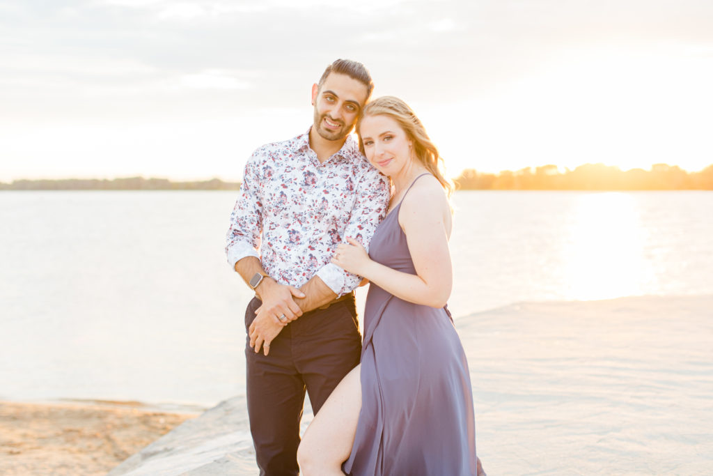 Cute Poses on the beach - Ideas for what to wear for Engagement Photography, Modern Engagement Session Inspiration Wardrobe Ideas. Unsure of what to wear for your engagement photos, we've got you! Romantic floral shirt & jeans.  White T-shirt & neutral pants . Boat Shoes and Fancy. beaded sandals. Engagement at Petrie Island, Orleans. Grey Loft Studio is Ottawa's Wedding and Engagement Photographer Videographer for Real couples, showcasing photos that are modern, bright, and fun.
