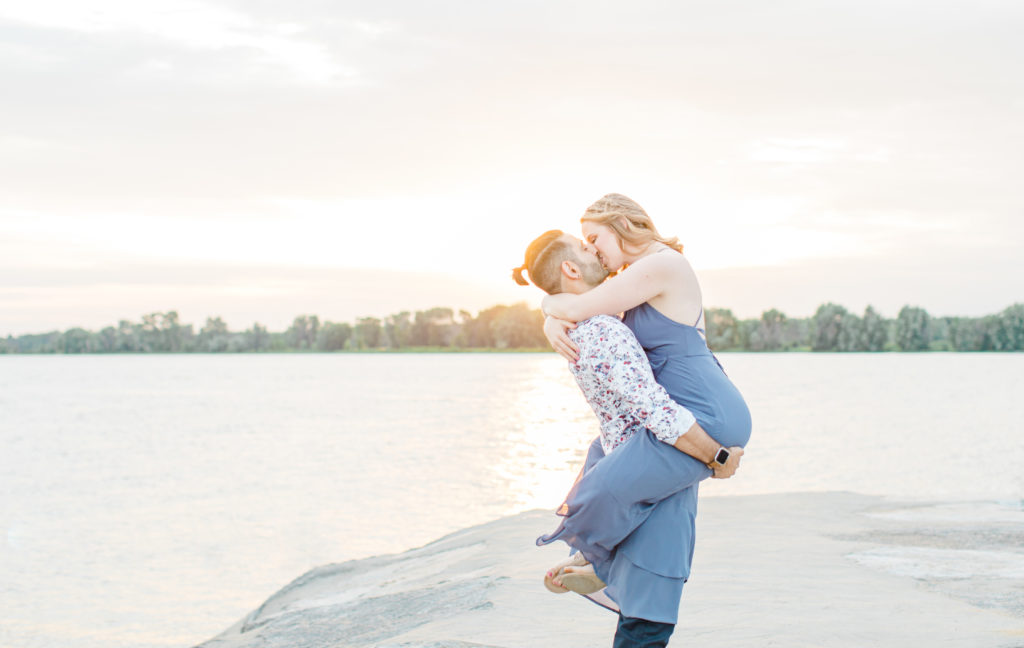 Cute Poses on the beach - Ideas for what to wear for Engagement Photography, Modern Engagement Session Inspiration Wardrobe Ideas. Unsure of what to wear for your engagement photos, we've got you! Romantic floral shirt & jeans.  White T-shirt & neutral pants . Boat Shoes and Fancy. beaded sandals. Engagement at Petrie Island, Orleans. Grey Loft Studio is Ottawa's Wedding and Engagement Photographer Videographer for Real couples, showcasing photos that are modern, bright, and fun.