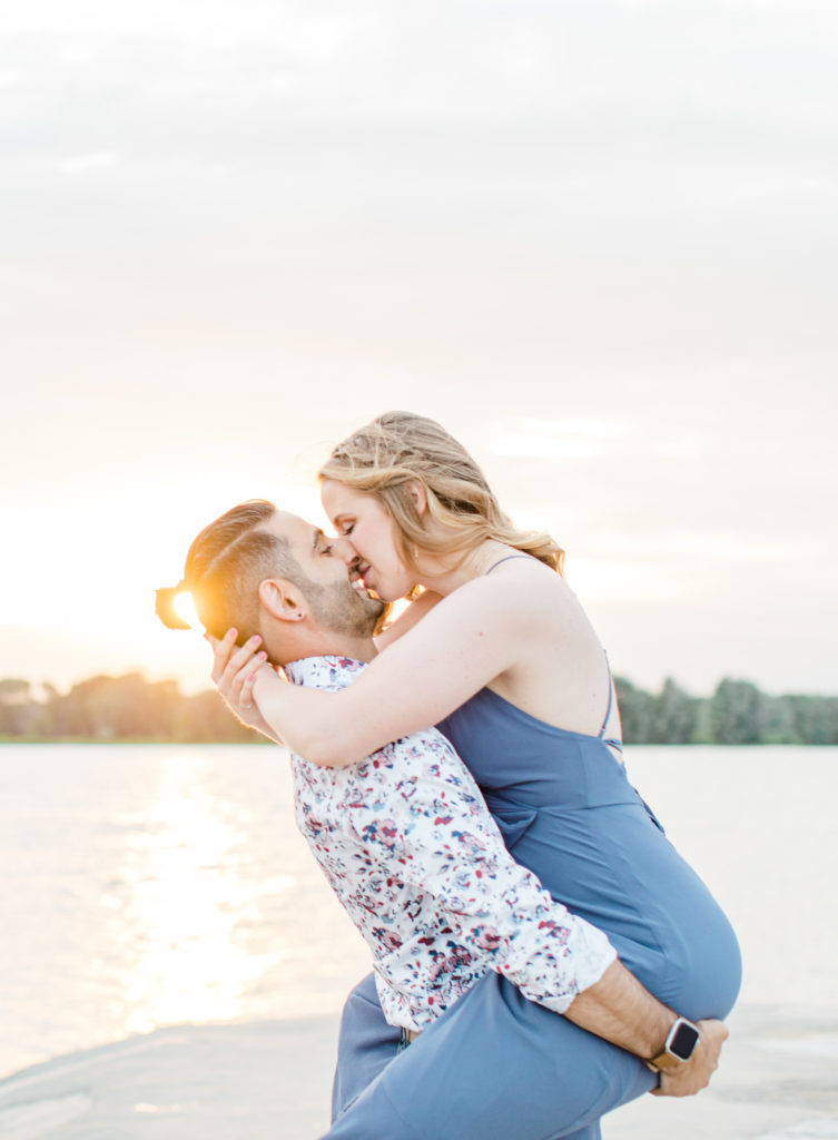 Cute Poses on the beach - Ideas for what to wear for Engagement Photography, Modern Engagement Session Inspiration Wardrobe Ideas. Unsure of what to wear for your engagement photos, we've got you! Romantic floral shirt & jeans.  White T-shirt & neutral pants . Boat Shoes and Fancy. beaded sandals. Engagement at Petrie Island, Orleans. Grey Loft Studio is Ottawa's Wedding and Engagement Photographer Videographer for Real couples, showcasing photos that are modern, bright, and fun.
