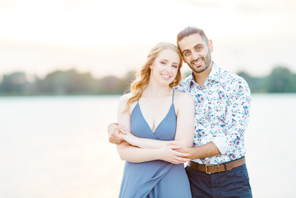 Cute Poses on the beach - Ideas for what to wear for Engagement Photography, Modern Engagement Session Inspiration Wardrobe Ideas. Unsure of what to wear for your engagement photos, we've got you! Romantic floral shirt & jeans.  White T-shirt & neutral pants . Boat Shoes and Fancy. beaded sandals. Engagement at Petrie Island, Orleans. Grey Loft Studio is Ottawa's Wedding and Engagement Photographer Videographer for Real couples, showcasing photos that are modern, bright, and fun.