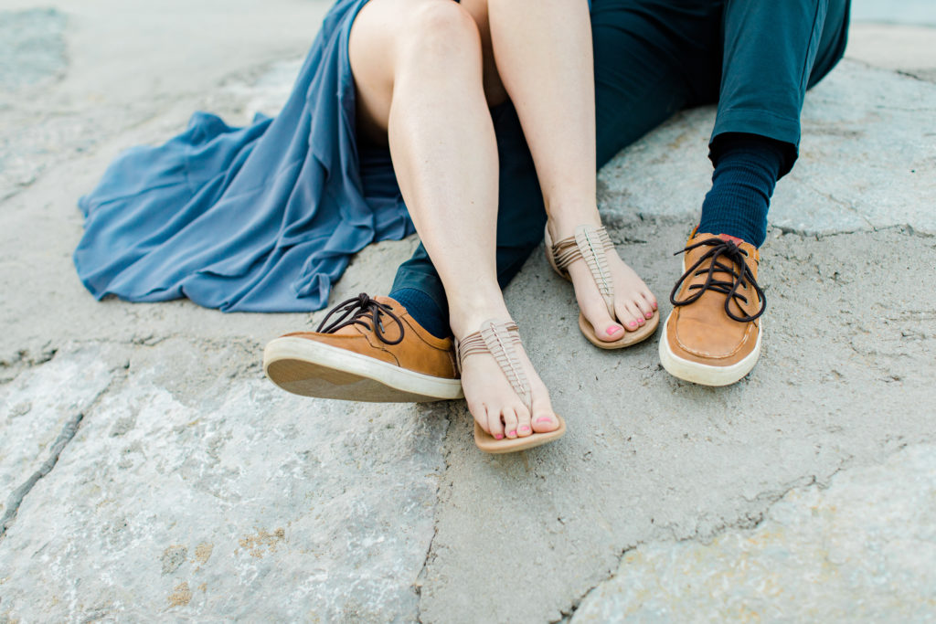 Cute Poses on the beach - Ideas for what to wear for Engagement Photography, Modern Engagement Session Inspiration Wardrobe Ideas. Unsure of what to wear for your engagement photos, we've got you! Romantic floral shirt & jeans.  White T-shirt & neutral pants . Boat Shoes and Fancy. beaded sandals. Engagement at Petrie Island, Orleans. Grey Loft Studio is Ottawa's Wedding and Engagement Photographer Videographer for Real couples, showcasing photos that are modern, bright, and fun.