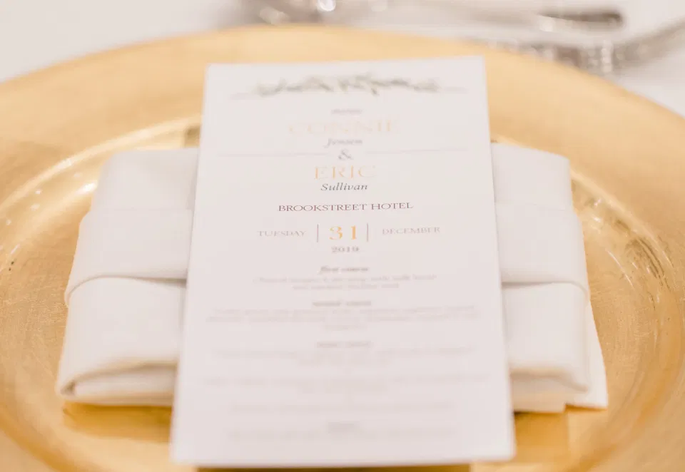 Wishtree Invitations - Menu - Gold Charger Plates - Winter Wedding - Bride with Bridesmaids - Gold, White, Greenery with Brown Furs - NYE Wedding - Natural Wedding Posing - Ideas for what to wear for Wedding on NYE Photography, Modern Wedding NYE Wardrobe inspiration- Unsure of what to wear for your wedding, we've got you! Romantic white with greenery theme. Lace Wedding Dress in Ottawa. Grey Loft Studio is Ottawa's Wedding and Engagement Photographer & Videographer for Real couples, showcasing photos that are modern, bright, and fun. Brookstreet Hotel Kanata