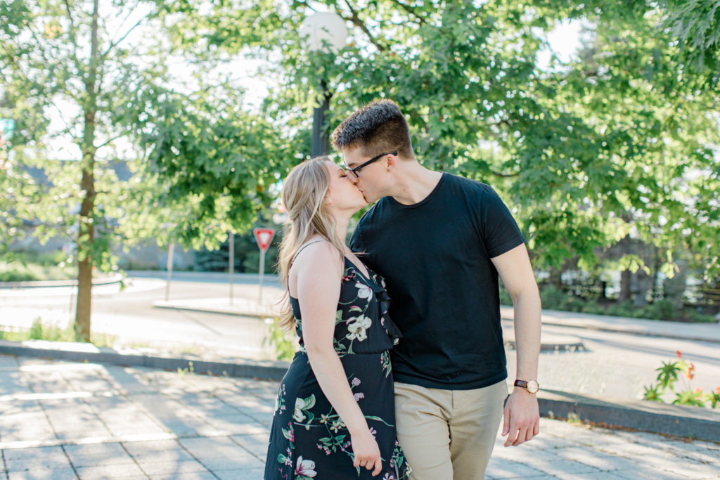 Cute couple Posing at Rideau Hall - Ideas for what to wear for Engagement Photography, Modern Engagement Session Inspiration Wardrobe Ideas. Unsure of what to wear for your engagement photos, we've got you! Romantic floral dress. Black Polo T-shirt & neutral pants . Boat Shoes and Fancy beaded wedges. Engagement downtown Ottawa. Grey Loft Studio is Ottawa's Wedding and Engagement Photographer Videographer for Real couples, showcasing photos that are modern, bright, and fun.