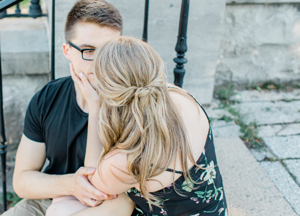 Engagement Session Hair Inspiration - Cute couple Posing while sitting on steps at Rideau Hall - Ideas for what to wear for Engagement Photography, Modern Engagement Session Inspiration Wardrobe Ideas. Unsure of what to wear for your engagement photos, we've got you! Romantic floral dress. Black Polo T-shirt & neutral pants . Boat Shoes and Fancy beaded wedges. Engagement downtown Ottawa. Grey Loft Studio is Ottawa's Wedding and Engagement Photographer Videographer for Real couples, showcasing photos that are modern, bright, and fun.