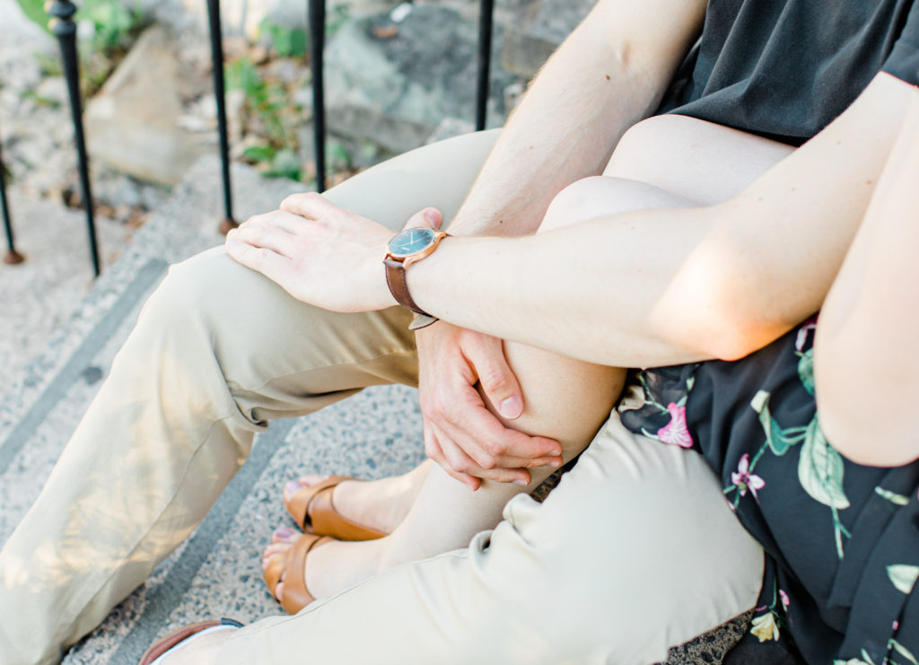Engagement Photo Poses- Cute couple Posing while sitting on steps at Rideau Hall - Ideas for what to wear for Engagement Photography, Modern Engagement Session Inspiration Wardrobe Ideas. Unsure of what to wear for your engagement photos, we've got you! Romantic floral dress. Black Polo T-shirt & neutral pants . Boat Shoes and Fancy beaded wedges. Engagement downtown Ottawa. Grey Loft Studio is Ottawa's Wedding and Engagement Photographer Videographer for Real couples, showcasing photos that are modern, bright, and fun.