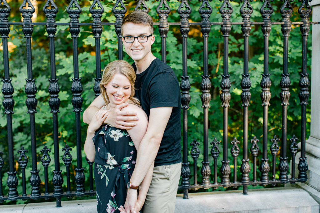 Holding Hands Shot - Engagement Photo Poses- Posing while at Rideau Hall - Ideas for what to wear for Engagement Photography, Modern Engagement Session Inspiration Wardrobe Ideas. Unsure of what to wear for your engagement photos, we've got you! Romantic floral dress. Black Polo T-shirt & neutral pants . Boat Shoes and Fancy beaded wedges. Engagement downtown Ottawa. Grey Loft Studio is Ottawa's Wedding and Engagement Photographer Videographer for Real couples, showcasing photos that are modern, bright, and fun.