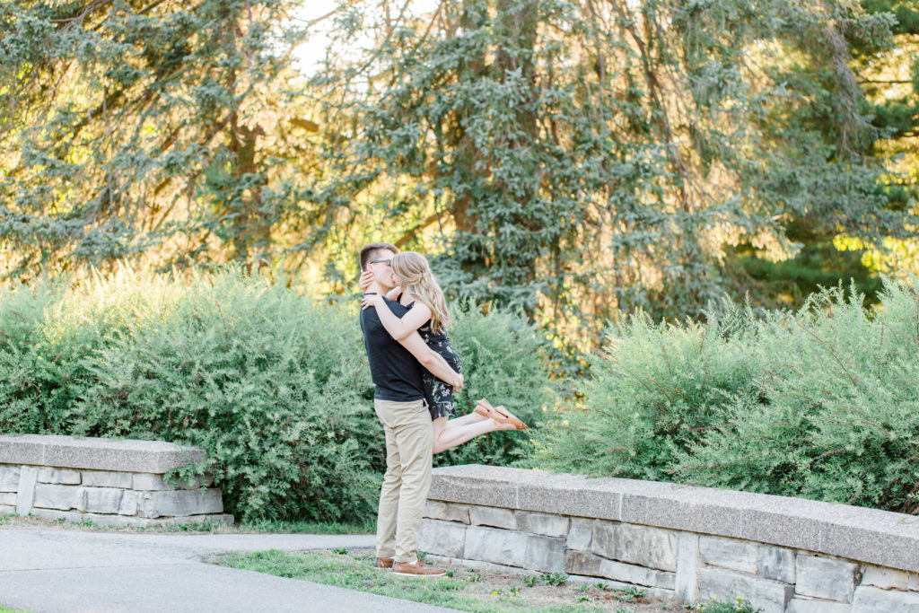 The lift - Cute Posing for Tall guys with short girls - Holding Hands Shot - Engagement Photo Poses- Posing while at Rideau Hall - Ideas for what to wear for Engagement Photography, Modern Engagement Session Inspiration Wardrobe Ideas. Unsure of what to wear for your engagement photos, we've got you! Romantic floral dress. Black Polo T-shirt & neutral pants . Boat Shoes and Fancy beaded wedges. Engagement downtown Ottawa. Grey Loft Studio is Ottawa's Wedding and Engagement Photographer Videographer for Real couples, showcasing photos that are modern, bright, and fun.