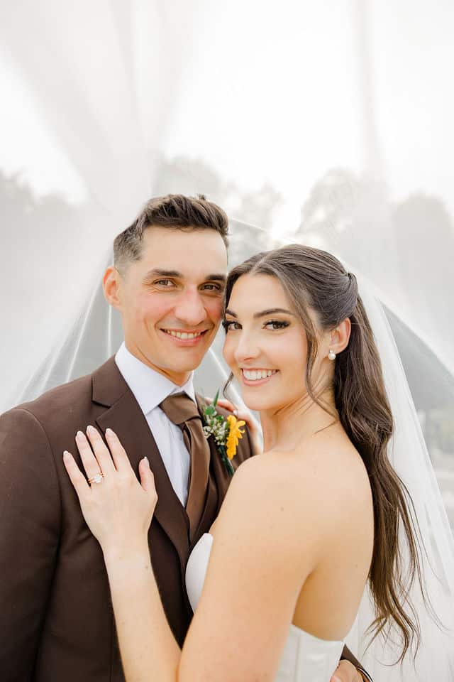 Julia and Will smiling at the camera during their portrait session