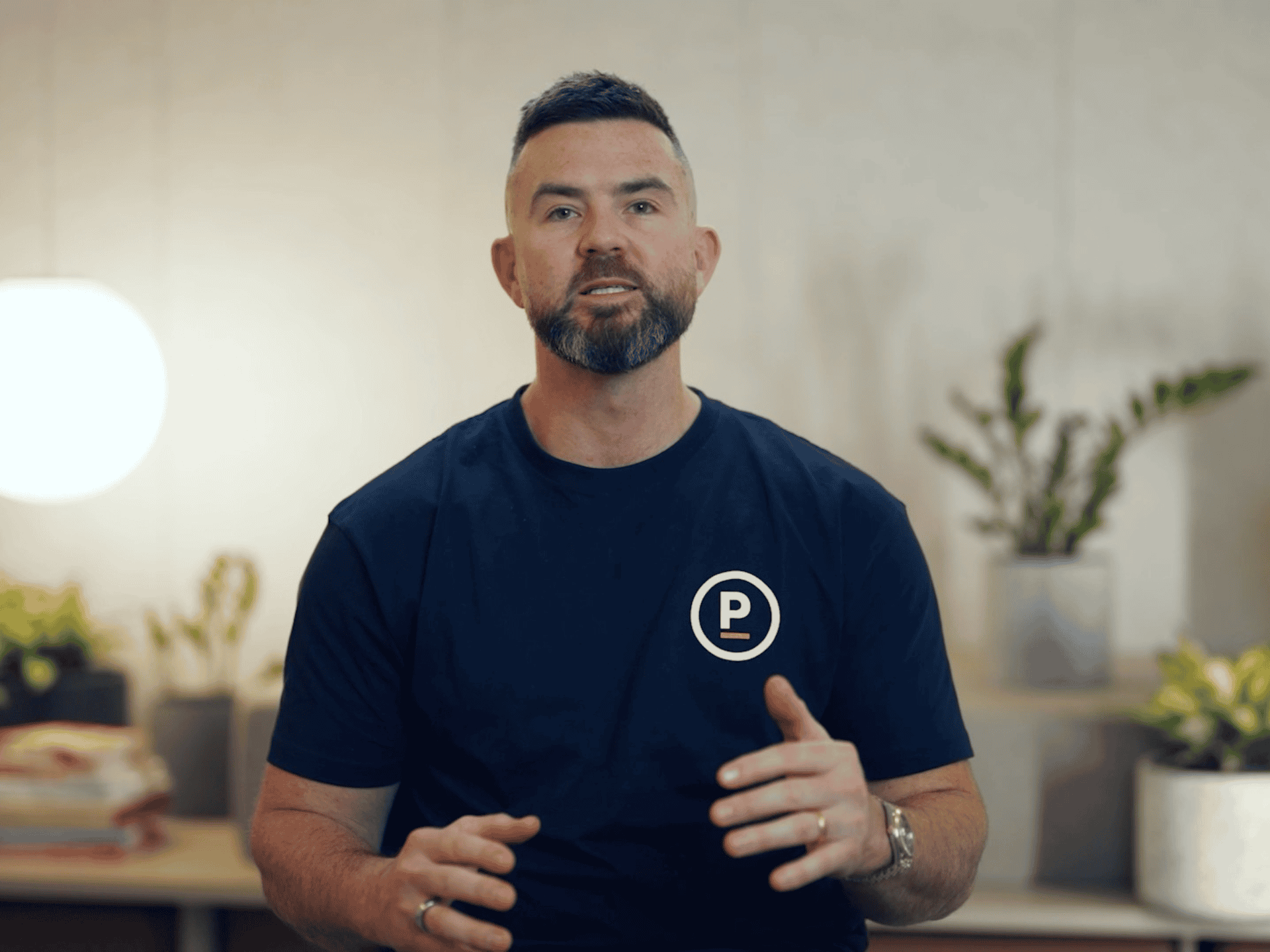 Pivot Wealth adviser in a branded T-shirt explaining how financial advice works