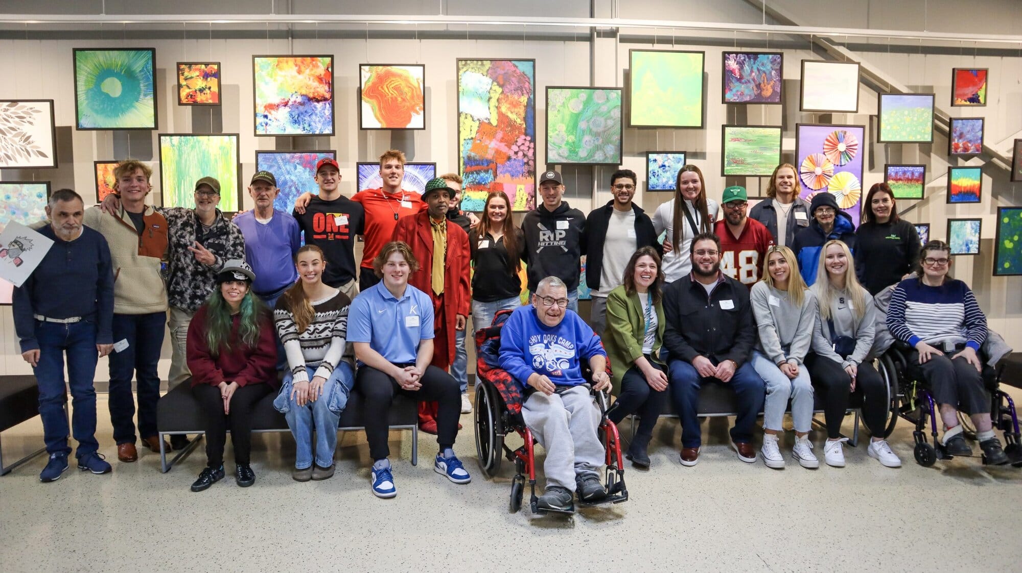 Jack Suwinski and RYP players posing with HH clients in front of client art gallery wall