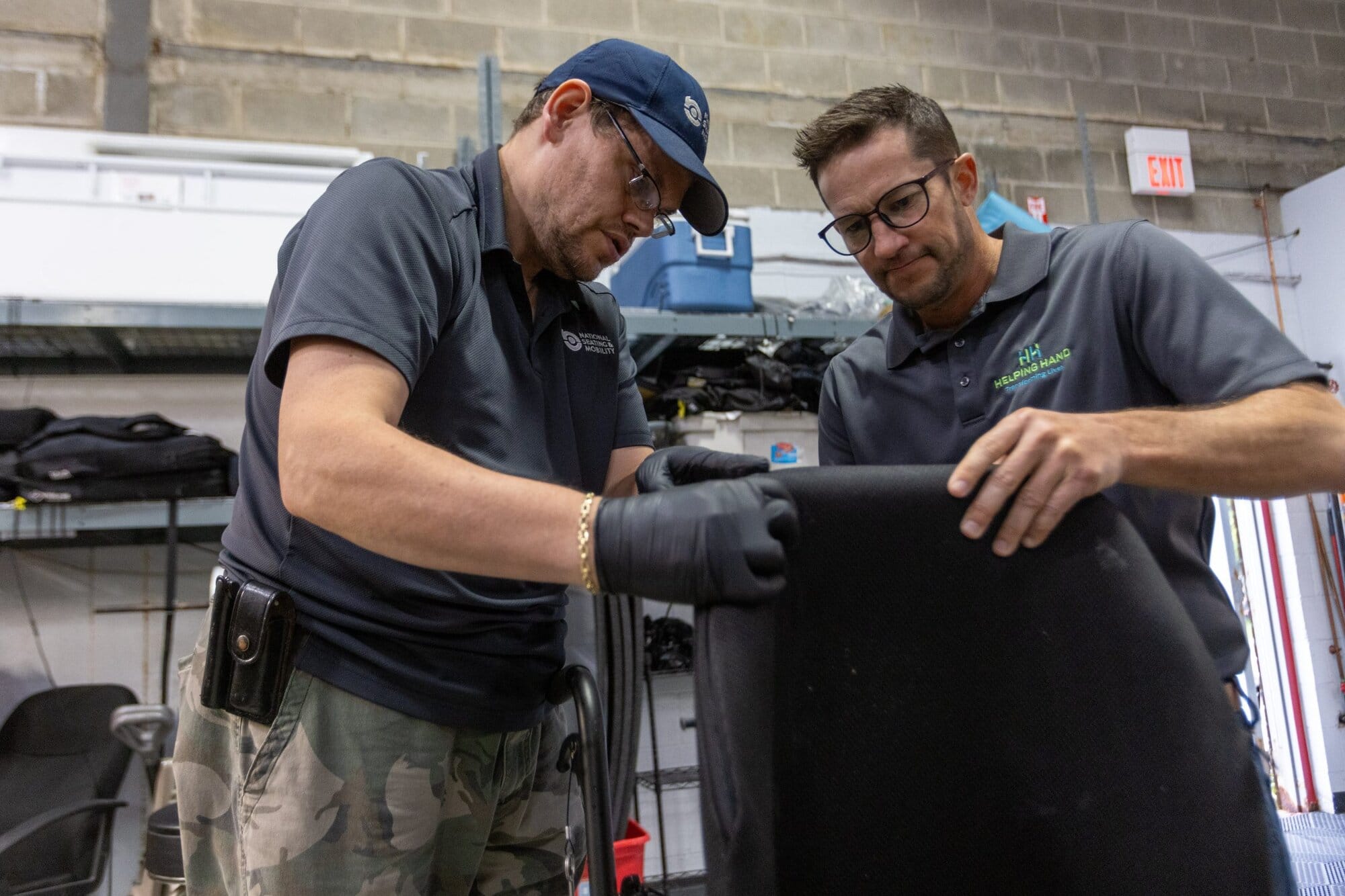 John showing HH team member, Keith, what he's been working on at his job at National Seating & Mobility