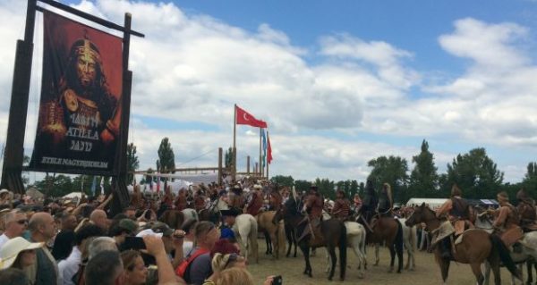 A portrait of Attila the Hun watches over Hungary’s Kurultaj festival of ancient Turkic cultures and traditions. Photograph: Daniel McLaughlin