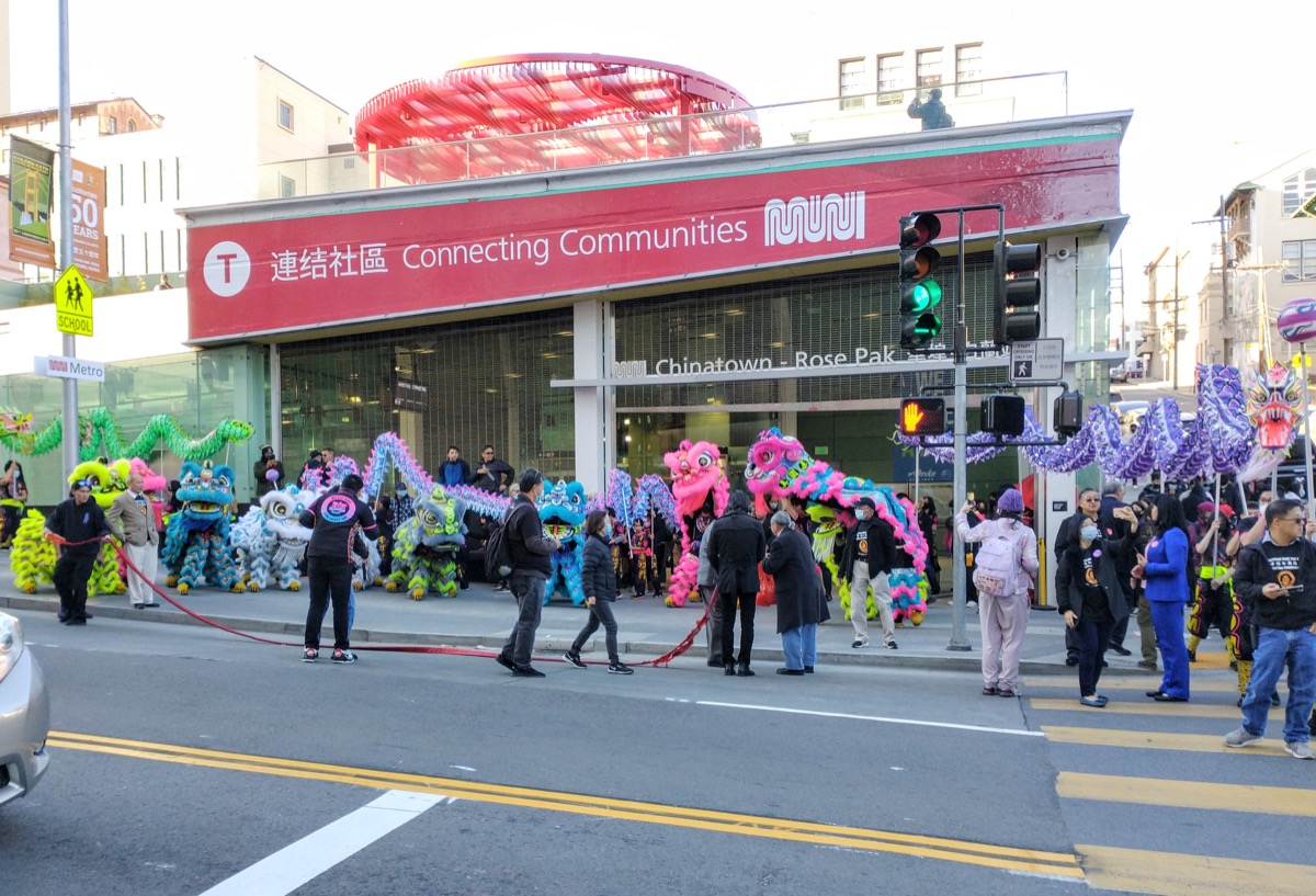 Lion and dragon dance troupes outside the Chinatown–Rose Pak station in San Francisco — an observance set by a local association.