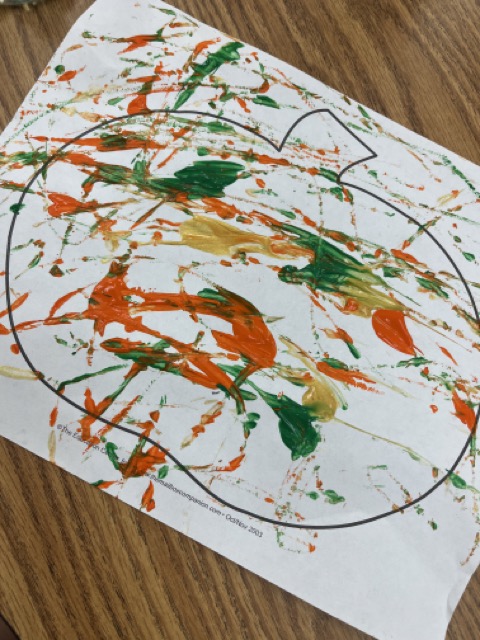 Photo of finished Marble Art Example of an Easy progressive art idea. Pumpkin with paint spread over it.