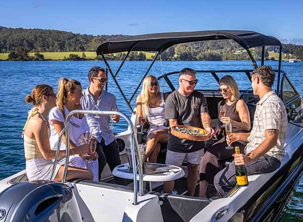 A group tasting oysters freshly picked and shucked in Narooma