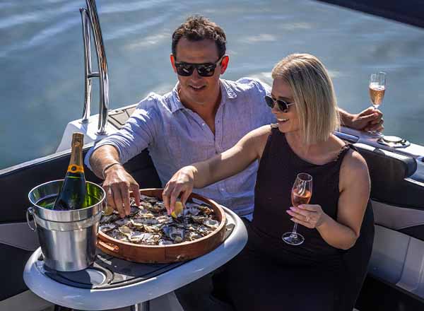 A couple tasting oysters freshly picked and shucked in Narooma