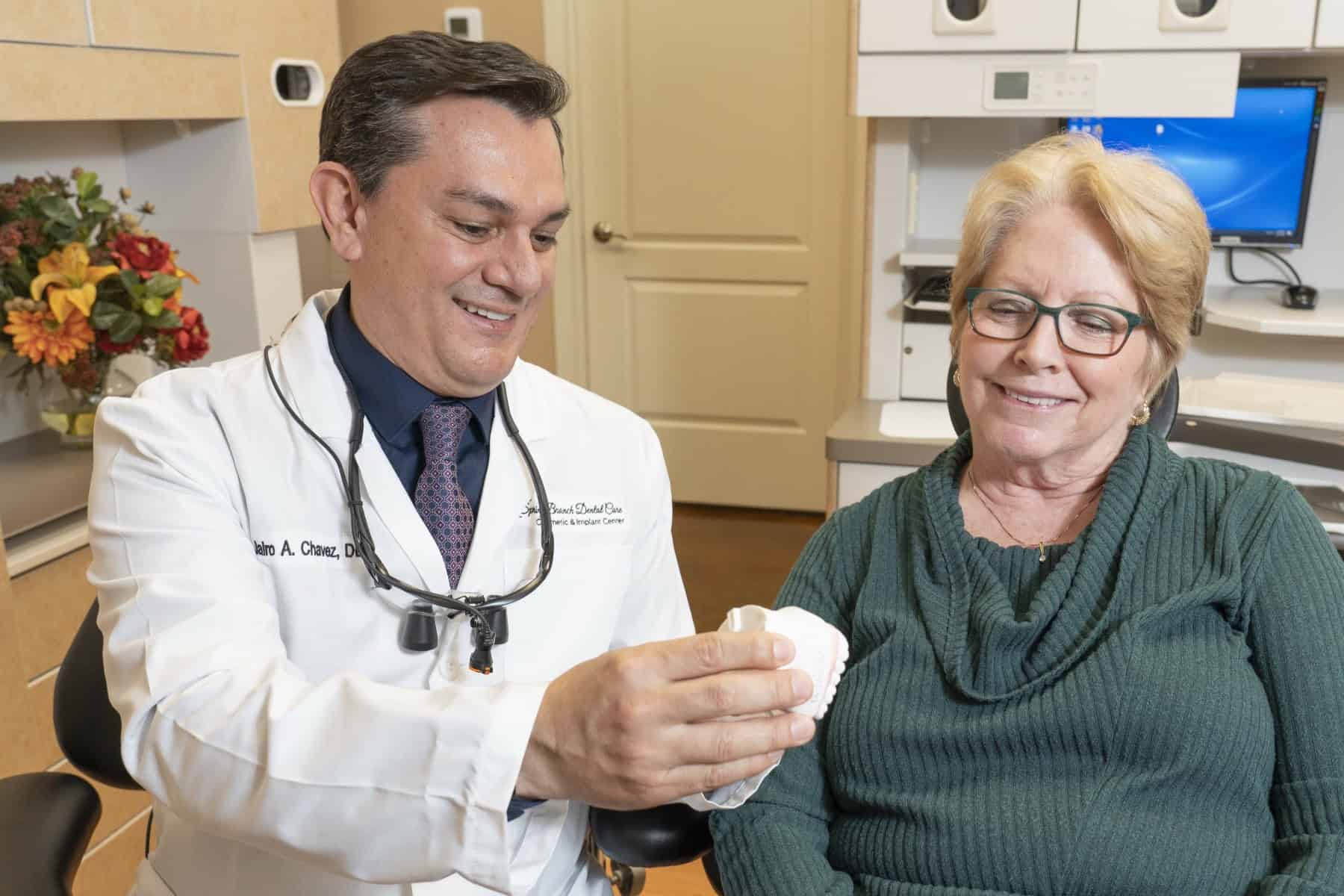 Dr. Chavez showing a patient a teeth model