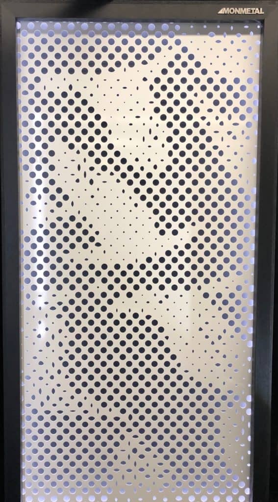 Decorative perforated metal panel with abstract design for architectural use.