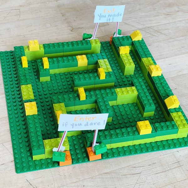 This image shows a corn maze made from Legos on a wooden table.