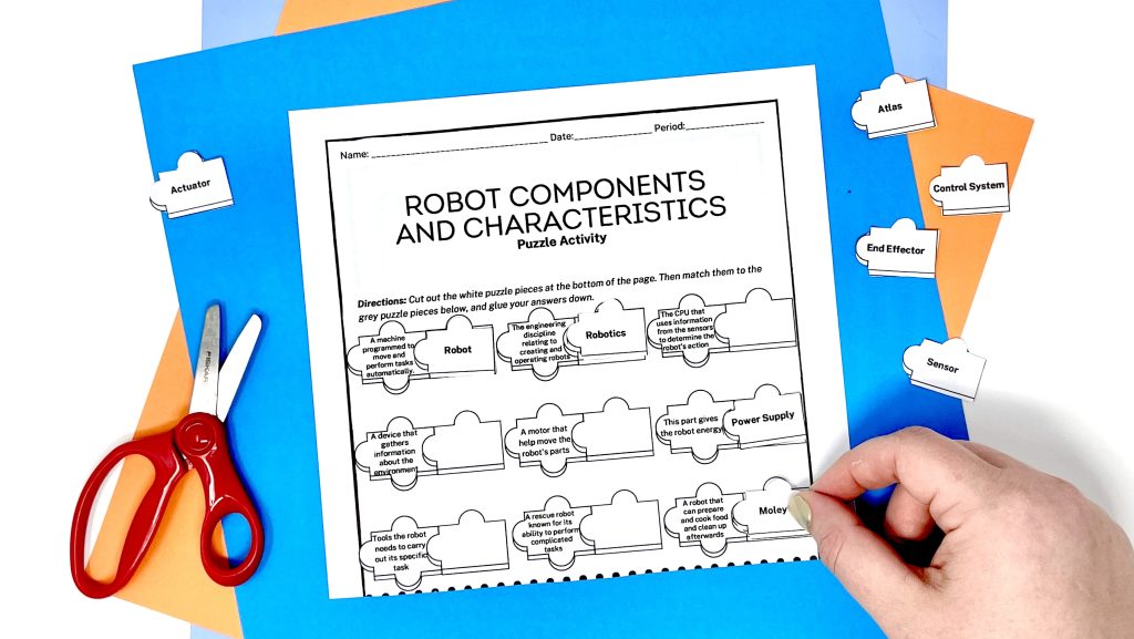 This image shows a hand matching Robotics vocabulary words to the definitions with a cut and paste activity.