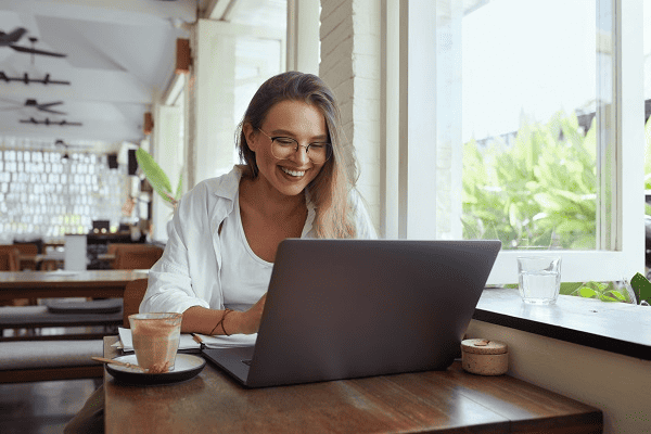 A freelance writer working on a laptop in a coffee shop