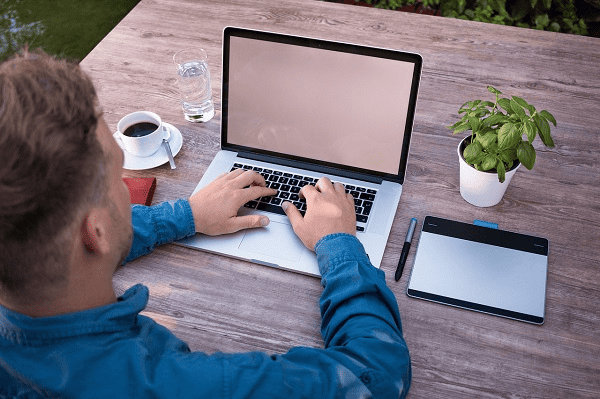 Person working on a laptop in a home office
