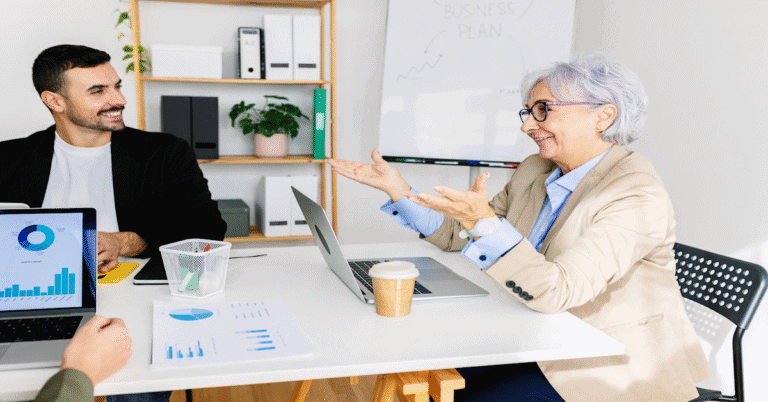 older woman coaching younger business peoiple