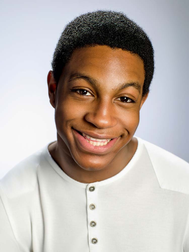 High-quality professional headshot of a smiling young African descendent man in a white shirt for Sussex headshots and business portraits, perfect for LinkedIn profiles and corporate branding.
