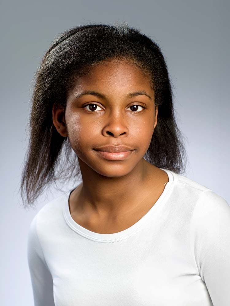 High-quality professional headshot of a young woman for corporate or personal branding, taken by Sussex Headshots, showcasing natural expression and confidence.