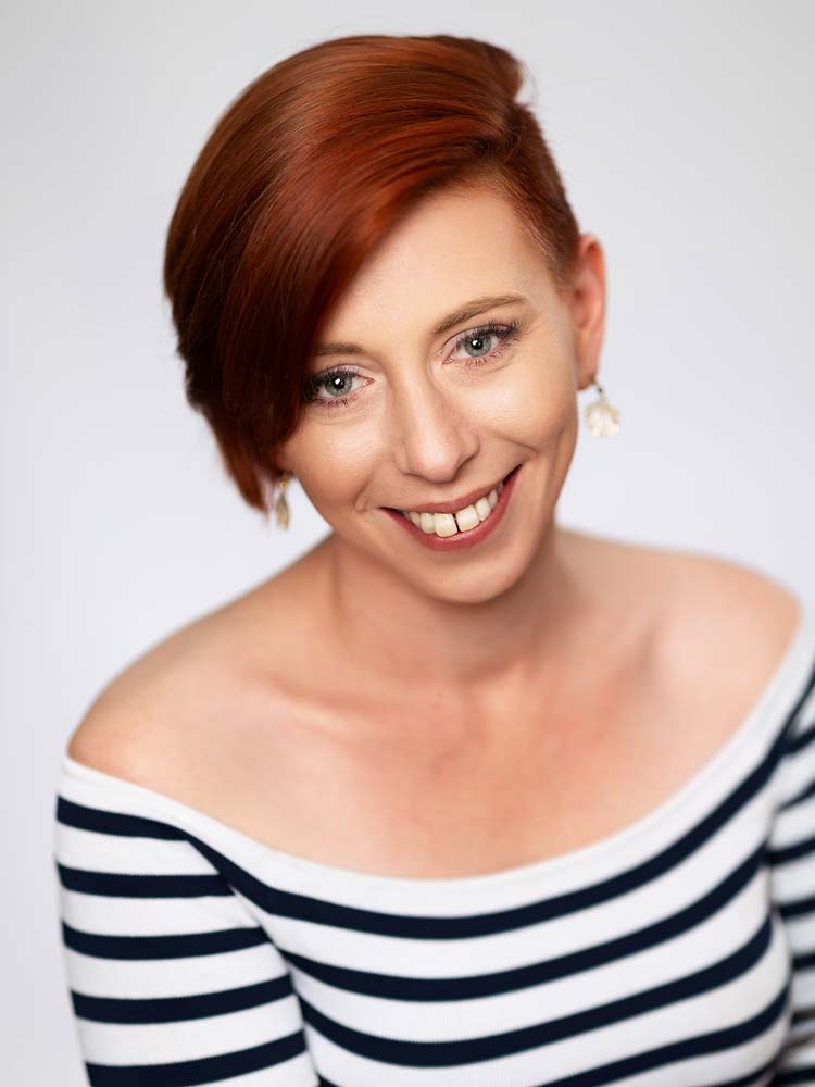 Casting headshots for actors. Vibrant red-haired woman headshot for Sussex Headshots, professional actor headshots and portrait photography. Confident spotlight headshot, modern Sussex photographer, UK professional headshot services.