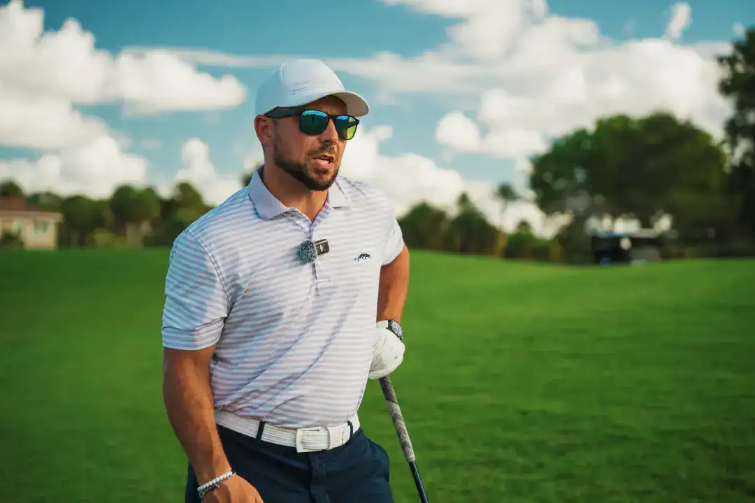Elegant businessman playing golf outdoors, representing luxury lifestyle, investment, or leisure activities associated with Syslo Ventures.