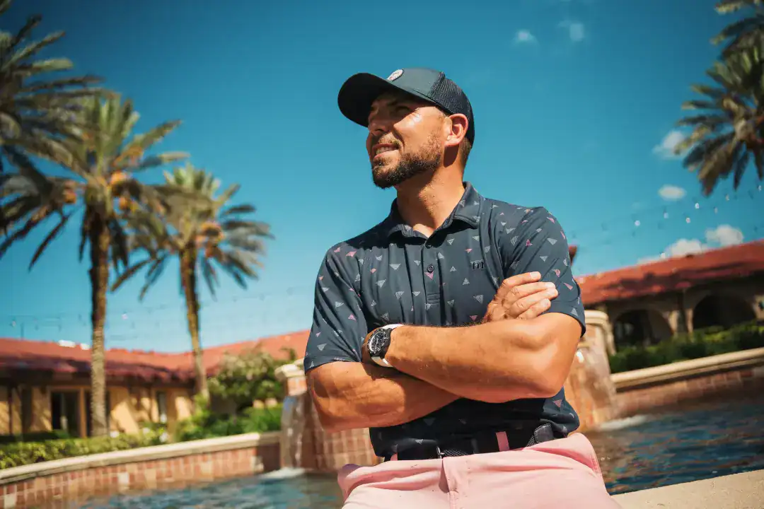 Modern businessman enjoying outdoor leisure at luxury resort, emphasizing investment in lifestyle and leisure ventures.