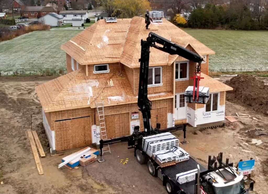 New home under construction with roofing and framing in progress in Ontario, Canada.