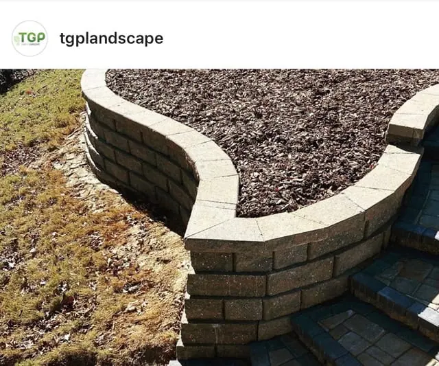 Retaining wall construction in Belmont NC shows how corner blocks at wall transitions help create cleaner lines and a more professional finished appearance