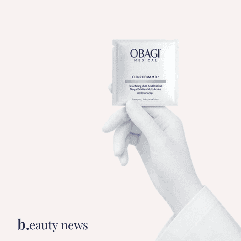 Obagi CLENZIderm M.D. peel pads held by a gloved hand.