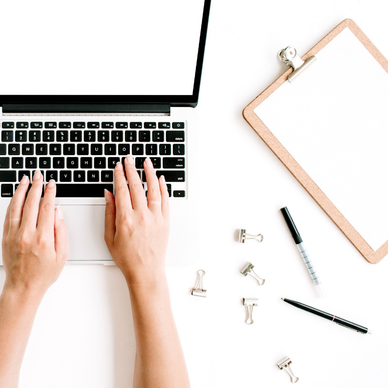 Woman's hands typing on computer for virtual therapy session