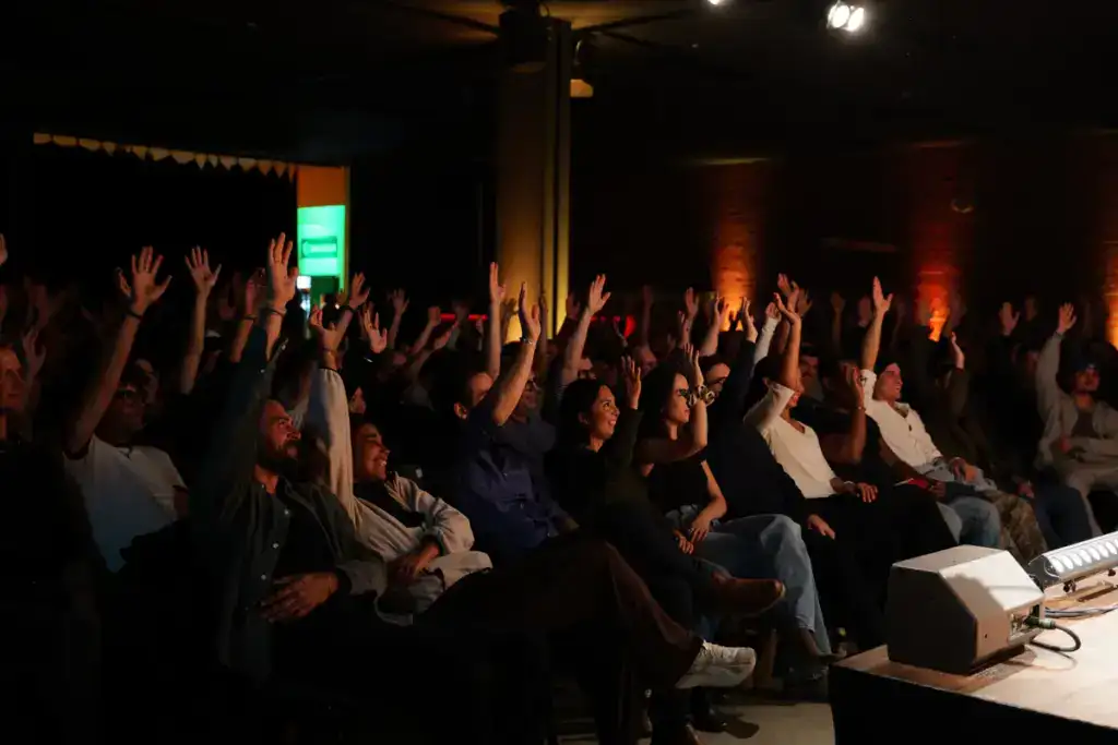 Audience raising hands at Scriptless improv comedy, The Jungle Comedy Club