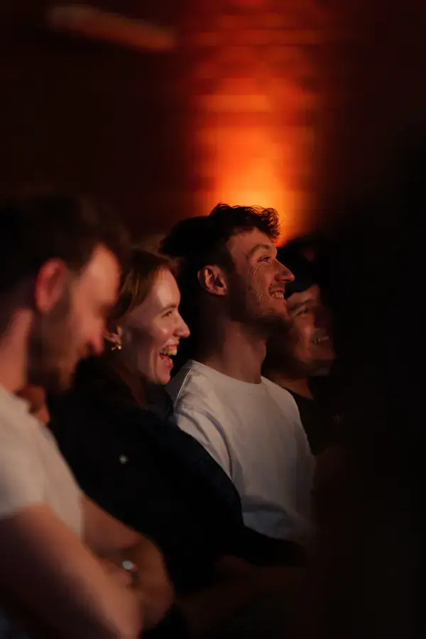Guests smiling at Scriptless improv comedy, The Jungle Comedy Club