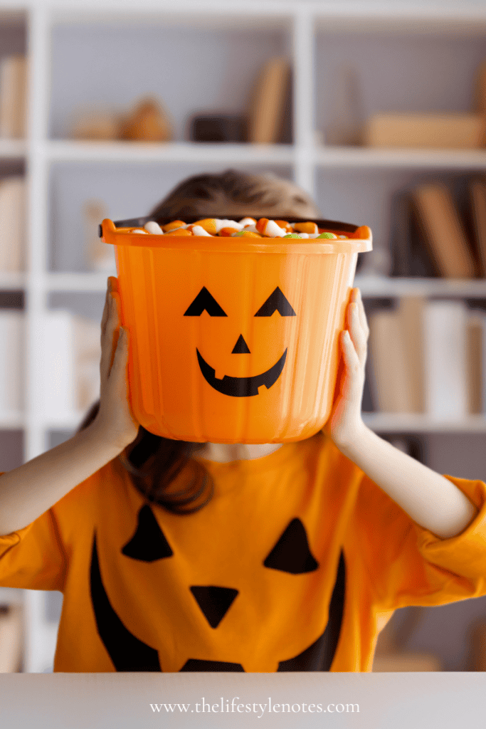 Fun Halloween Finds for Kids. Child holding a pumpkin basket full of candy.