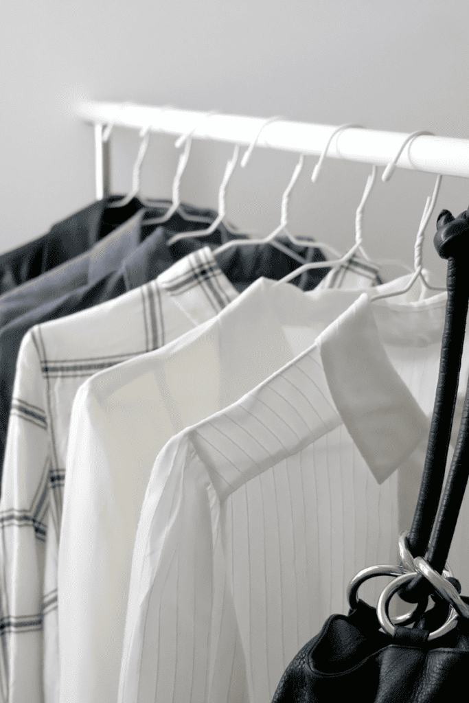 How To Create a Spring Capsule Wardrobe. Hanging rack with shirts on hangers.